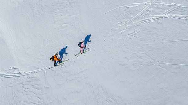 istock Ski Enthusiasts Navigating Alpine Terrain at Sunrise 2235714202