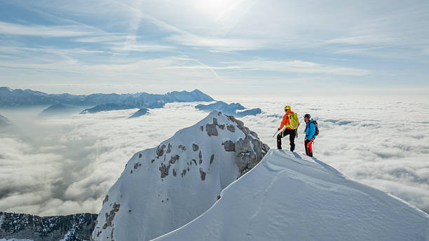 istock Experienced Mountaineers Reaching Snow-covered Summit 2235714217