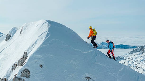 istock Climbers Ascending Steep Icy Path on Snow-covered Ridge 2235714239
