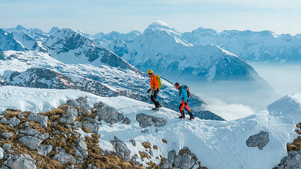 istock Mountaineers Navigating Snowy Ridge with Breathtaking Mountain Views 2235714240