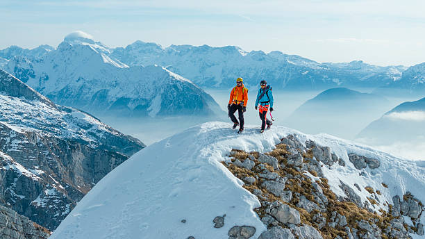 istock Mountaineers Walking on Snowy Ridge in Alpine Setting 2235714241