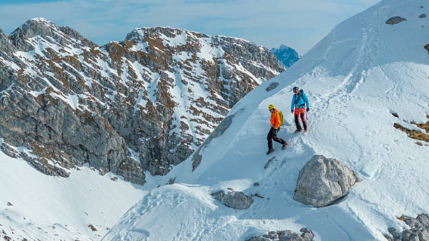 istock Experienced Mountaineers Traversing Snowy Mountain Ridge 2235714248