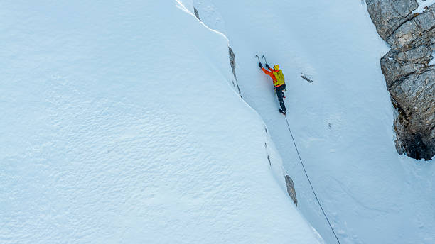 istock Mountaineer Tackling Icy Ascent with Ice Axes 2235714251