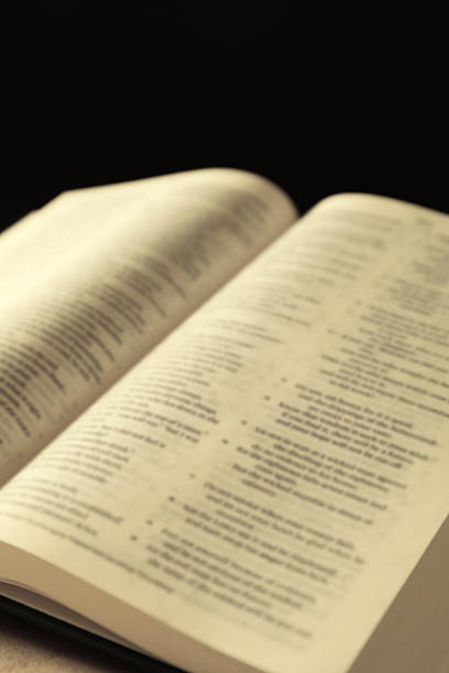 istock Open Holy Bible in English language on table, closeup 2235714853