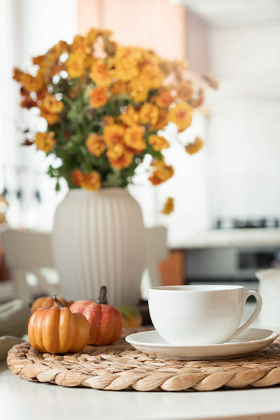 Warming autumn tea and candles at modern kitchen. Home interior. Tea time.