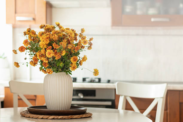 istock Cozy Kitchen Table with Flowers and Coffee Cup 2235715918