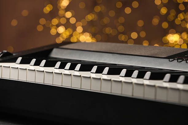 istock Piano against blurred lights, closeup. Bokeh effect 2235717117