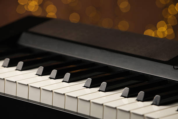 istock Piano against blurred lights, closeup. Bokeh effect 2235717125