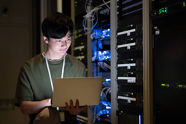 istock Japanese male engineer working in a server room 2235717302