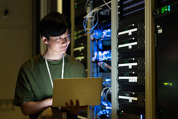istock Japanese male engineer working in a server room 2235717305