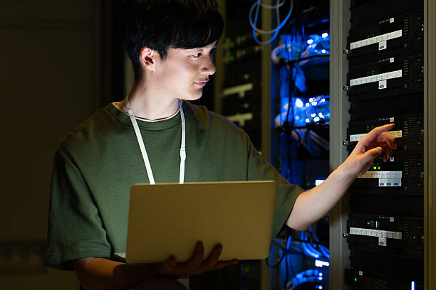 istock Japanese male engineer working in a server room 2235717307