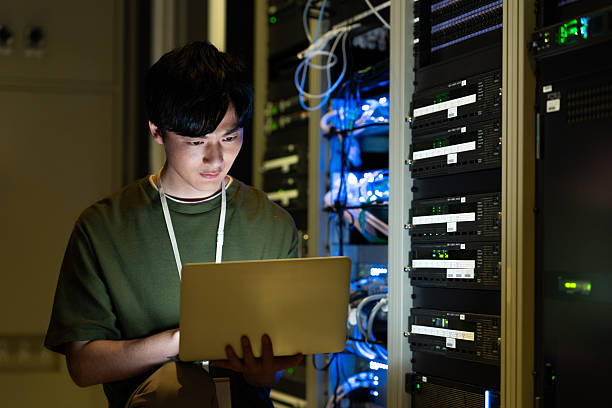 istock Japanese male engineer working in a server room 2235717309