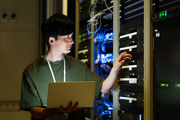 istock Japanese male engineer working in a server room 2235717311