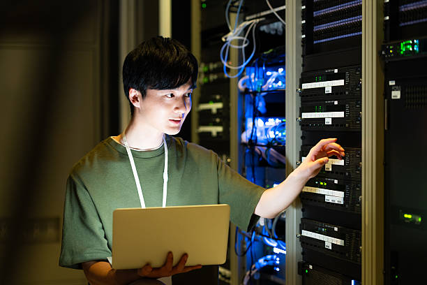 istock Japanese male engineer working in a server room 2235717315