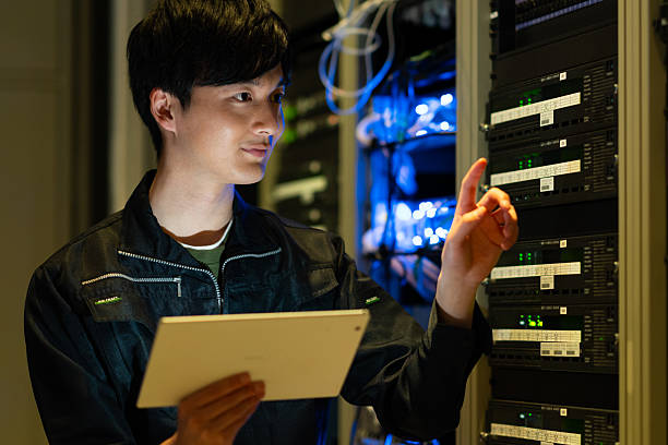 istock Japanese male engineer working in a server room 2235717323