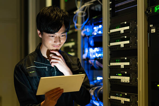 istock Japanese male engineer working in a server room 2235717330