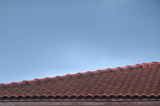 old red tile roof home and rain cloud floating in evening