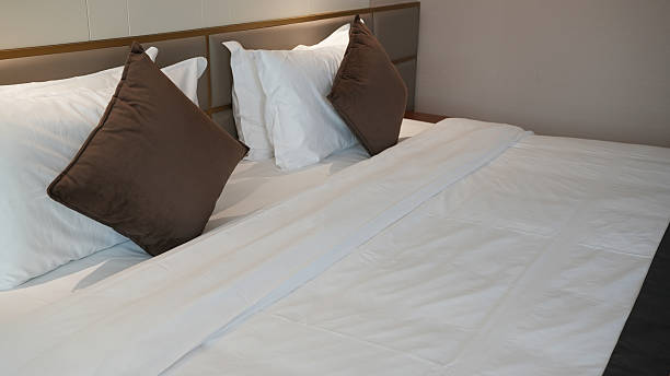 istock Hotel king-sized bed with pillows and cushions 2235717943