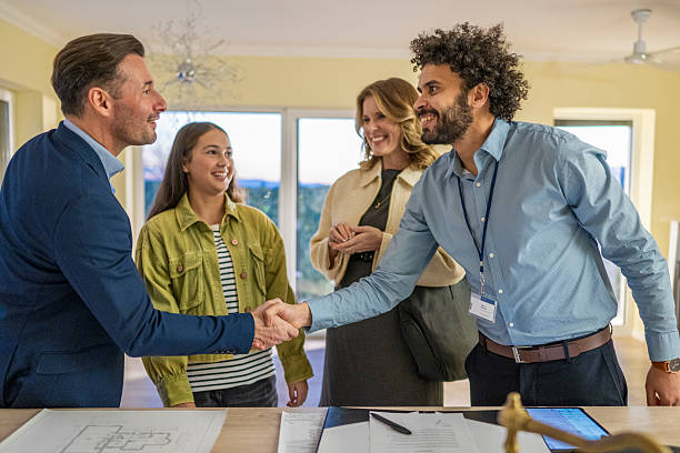 istock Middle Eastern Real Estate Agent Finalizing Agreement with Caucasian Clients 2235719897