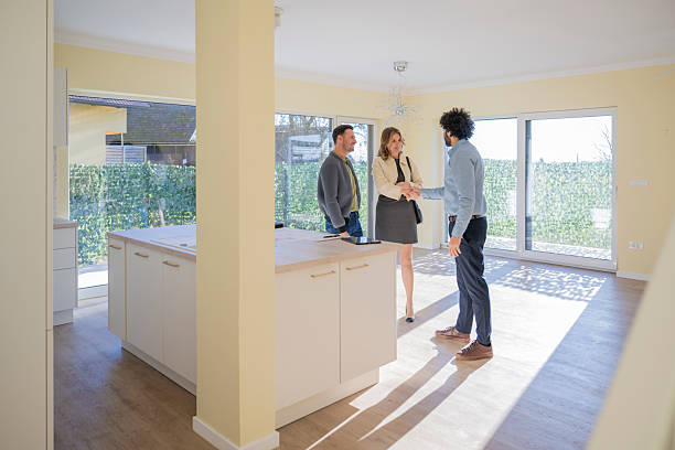 istock Middle Eastern Real Estate Agent Discussing Property with Caucasian Couple 2235719940