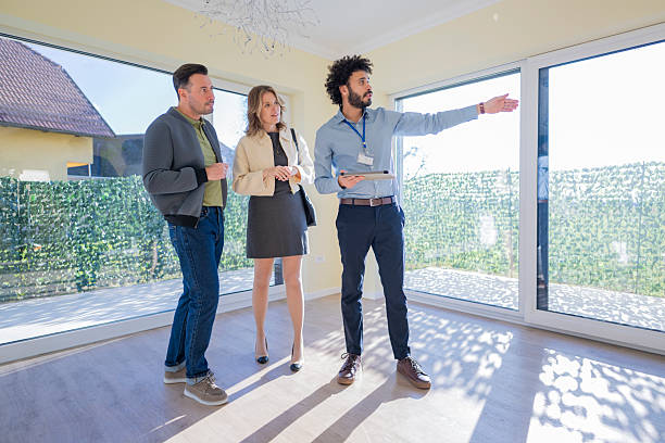 istock Middle Eastern Agent Presenting Home to Interested Couple 2235719950