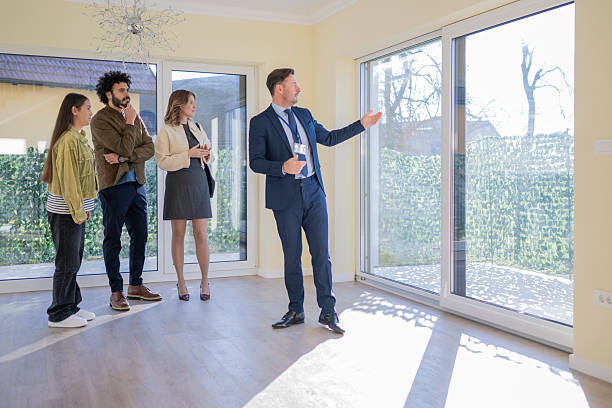 istock Caucasian Agent Presenting Modern Home to Diverse Group 2235719967
