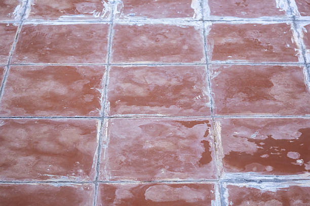 Red, plain, and newly completed terracotta floor tiles create a clean, minimalist texture and abstract background, perfect for showcasing a fresh architectural surface.