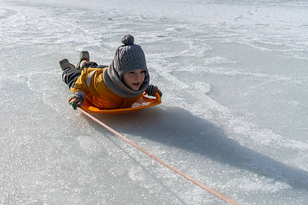 istock Child having fun in the snow, 2235720701