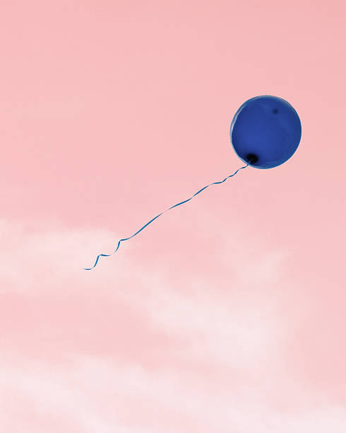 istock Blue balloon flying in the pink cloudy sky. Design element. Minimalism 2235721936