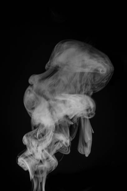 istock Ethereal wisps of smoke swirling gracefully against a dark backdrop creating a mesmerizing visual experience smoke art concept. graphic resource for montage, overlay or texture 2235724702