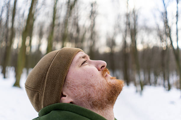 istock A man stands in a snowy forest. 2235725201