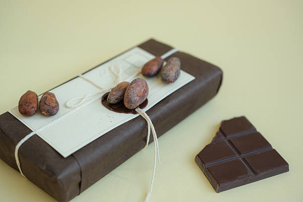 istock Chocolate parcel with sealing wax in sustainable packaging. Cocoa beans and broken chocolate. 2235725493
