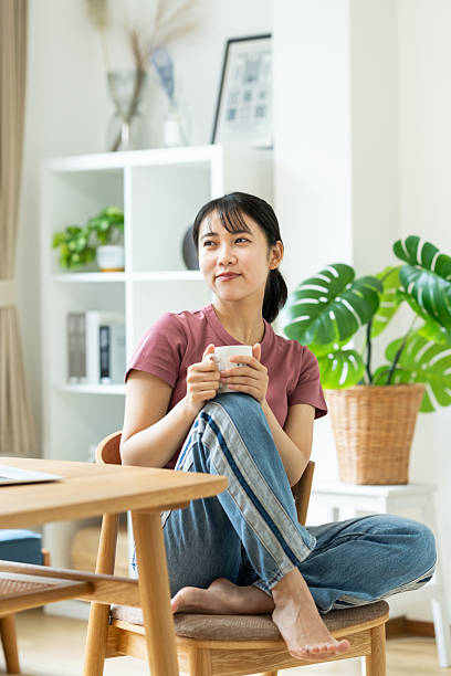 istock Young woman relaxing at home 2235726283