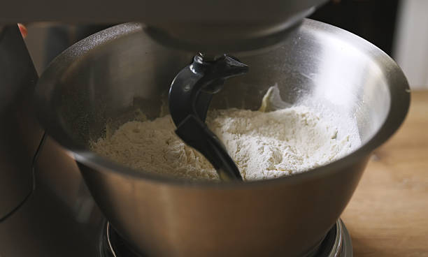 istock Planetary mixer kneading raw dough in metal bowl. 2235727751