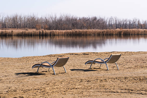Plastic beach chair against sea and mountains, travel concept.