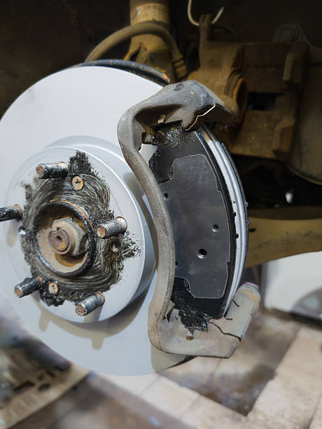 istock Car brake disc and pad closeup after replacement in workshop auto repair service 2235731548