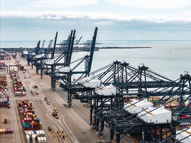 istock Cranes loading cargo containers at felixstowe port, england 2235738745