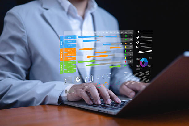 istock Businessman using laptop with digital project management dashboard, Gantt chart, task tracking, data analytics, productivity tools, workflow planning, and smart business organization technology. 2235741814