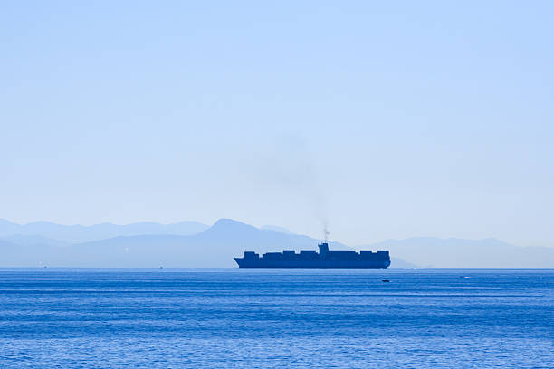 Alone barge in tranquil Mediterranean sea near Genoa harbor