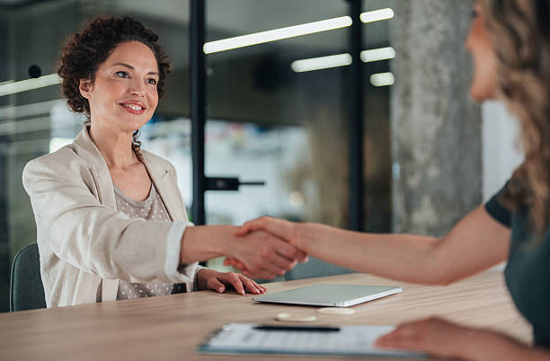istock Meeting success. Business partners shaking hands 2235745544