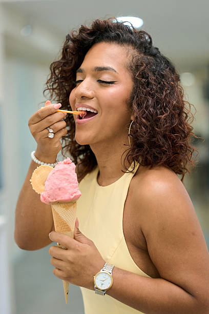 istock woman enjoying strawberry ice cream cone 2235747155