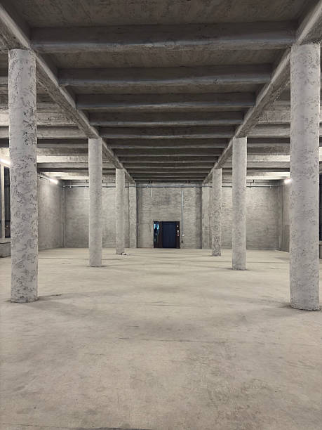 Industrial building interior with white brick walls, concrete floor and empty space for product display or industrial background