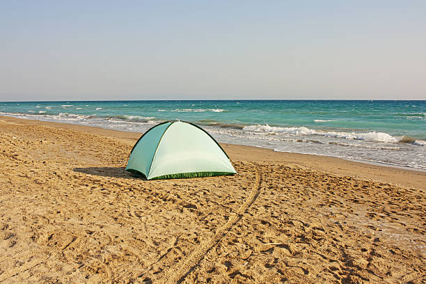 Tent on the seashore, sandy beach, silence, loneliness, sleep, overnight stay. High quality photo