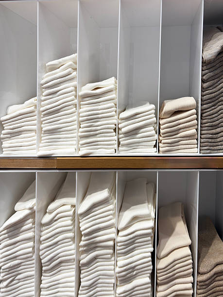 istock Multi colored socks stacked on shelves in the store 2235750227