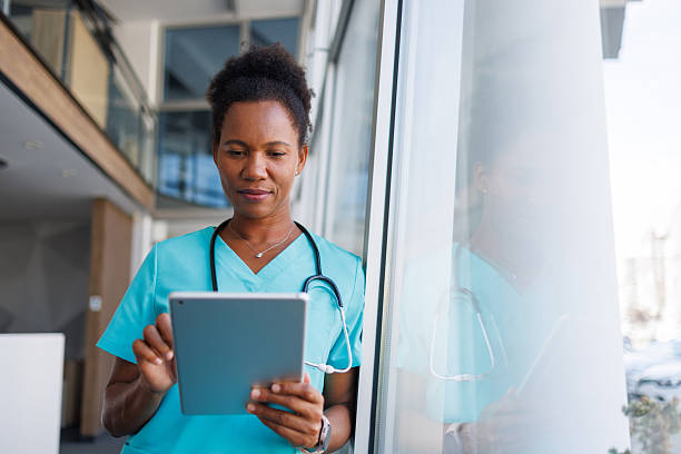 istock Confident african american nurse using digital tablet in hospital 2235752145