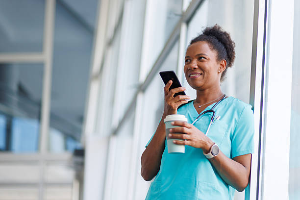 istock Doctor using mobile phone and drinking coffee during hospital break 2235752213