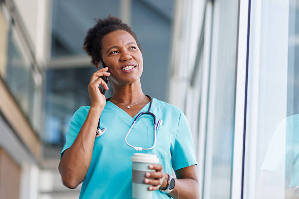 istock Smiling doctor making a phone call during coffee break 2235752486