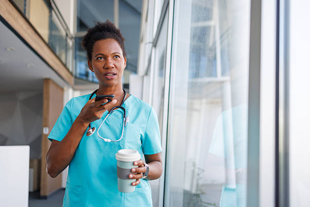 istock Doctor using mobile phone holding coffee inside hospital building 2235752498