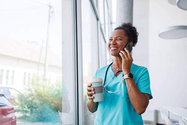 istock Smiling doctor making a phone call during coffee break 2235752516
