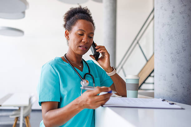 istock Doctor talking on the phone and taking notes in modern clinic 2235753095